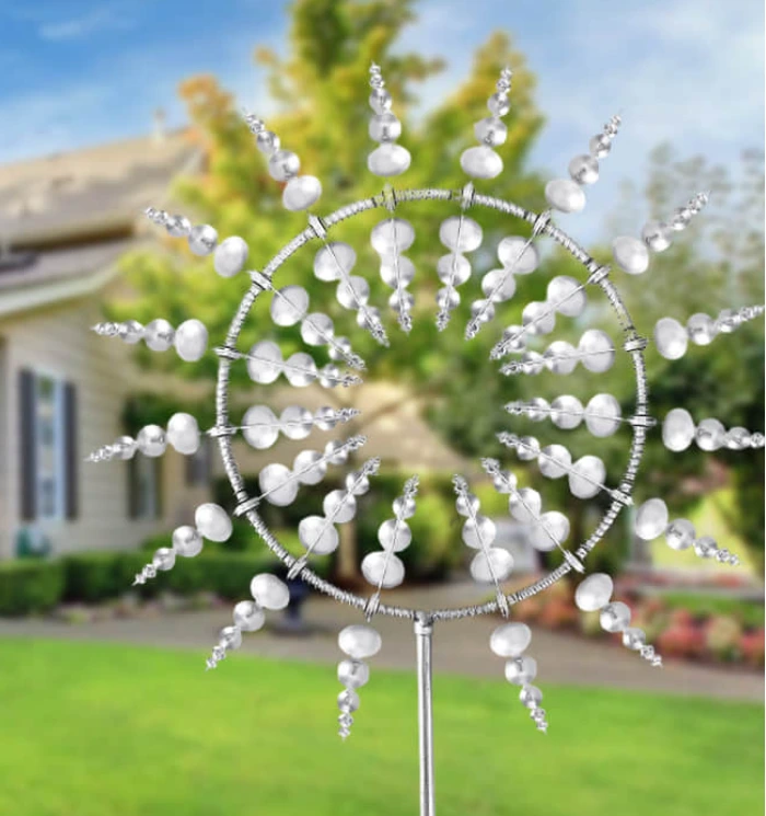 Image of the windmill in a garden in front of a house